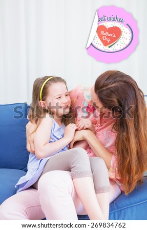 mothers day greeting against mother and daughter laughing on couch