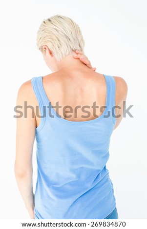 Casual woman suffering from neck ache on white background