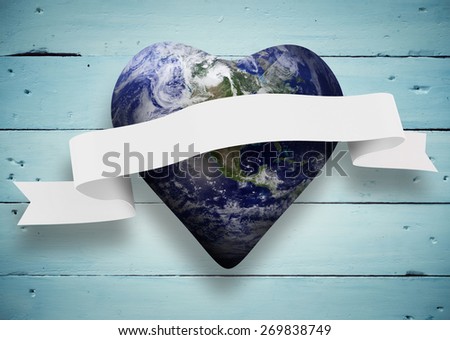 Heart shaped earth with scroll against painted blue wooden planks