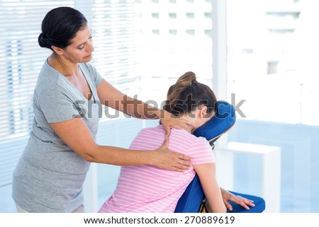 Woman having shoulders massage in medical office