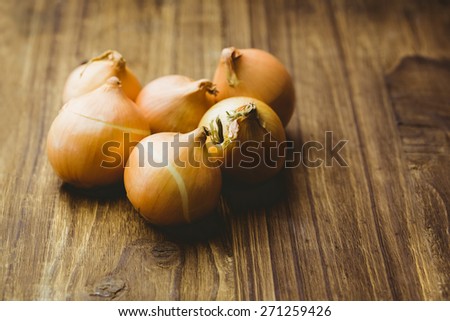 Fresh onions on wooden background