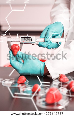Science and medical graphic against food scientist measuring a strawberry