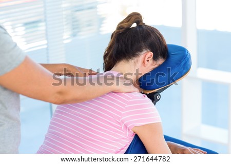 Woman having shoulders massage in medical office