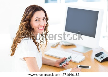 Smiling businesswoman looking at camera on white background