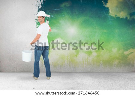 Happy man using paint roller against painted sky