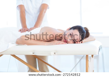 Woman having back massage in medical office