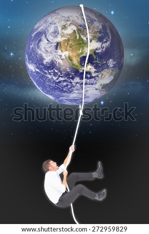 Businessman pulling a rope against stars twinkling in night sky