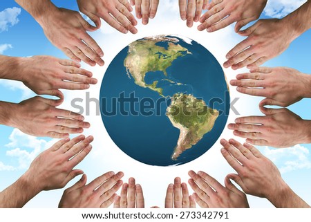 Circle of hands against blue sky
