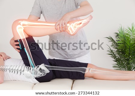 Digital composite of Highlighted bones of woman at physiotherapist