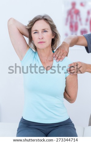 Woman stretching her arms in medical office