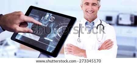 Man using tablet pc against empty bed in the hospital room