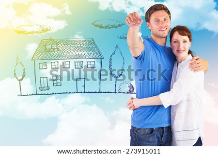Couple holding keys to home against blue sky