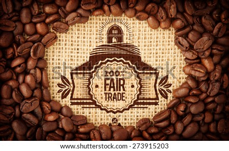 Fair Trade graphic against coffee beans with oval indent for copy space