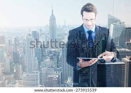 Businessman standing while using a tablet pc against new york