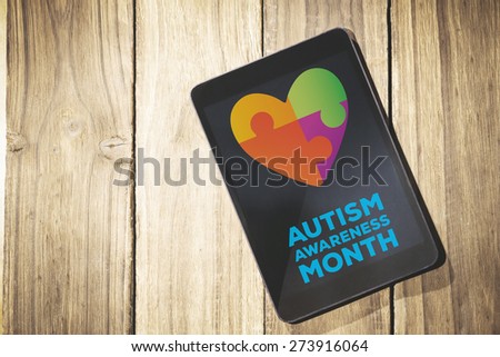autism awareness month against overhead of tablet on desk