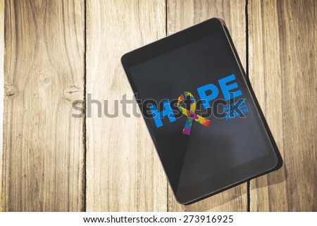 autism awareness month against overhead of tablet on desk