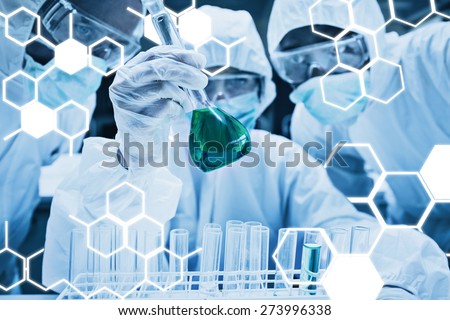 Science graphic against chemist mixing green liquid in beaker with two chemists watching