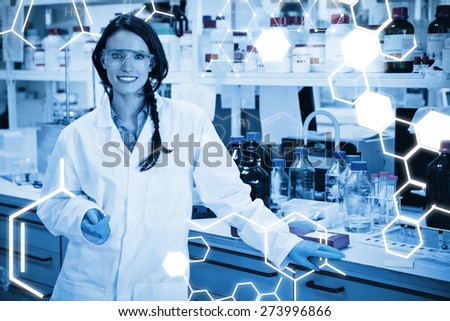 Science graphic against portrait of a smiling chemist leaning against desk