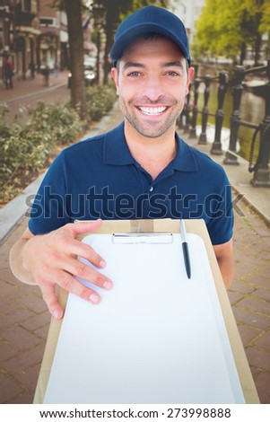 Happy delivery man with package and clipboard against bike path in amsterdam