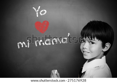 Spanish mothers day message against schoolchild with blackboard