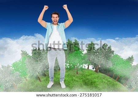 Happy casual man cheering at camera against bright blue sky over clouds