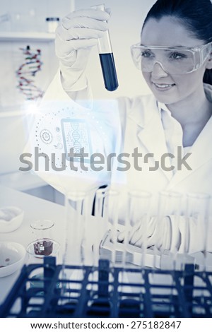 Science and medical graphic against attractive redhaired woman holding a test tube