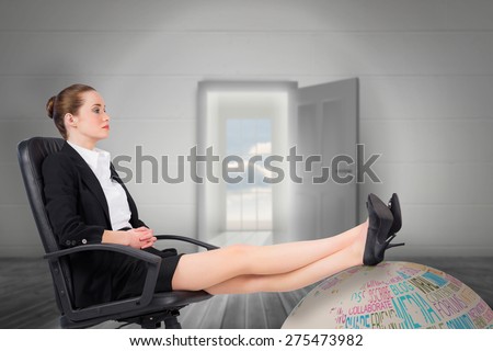 Businesswoman sitting on swivel chair with feet up against open door leading to bright window