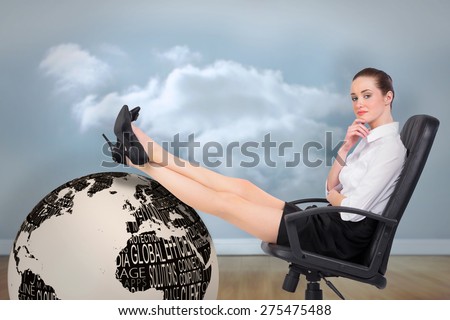 Businesswoman sitting on swivel chair with feet up against clouds in a room