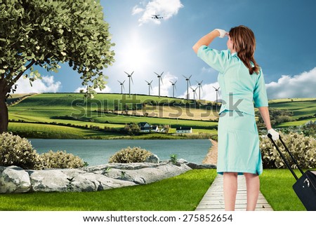 Air hostess against scenic backdrop