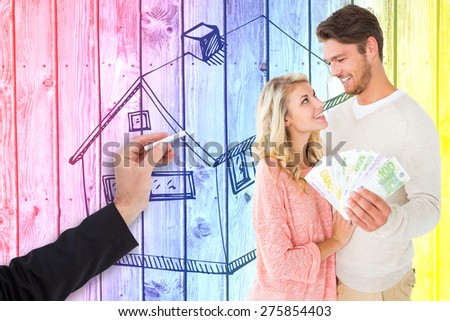 Attractive couple flashing their cash against digitally generated grey wooden planks