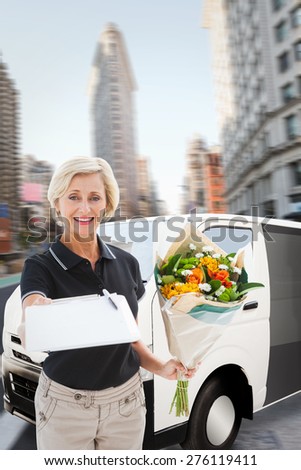 Happy flower delivery woman looking for signature against new york street