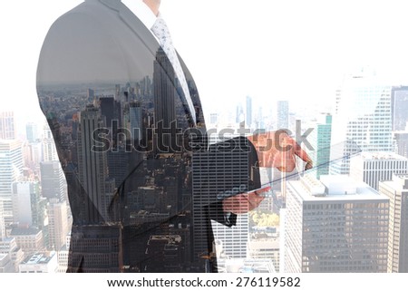 Businessman using his tablet pc against new york