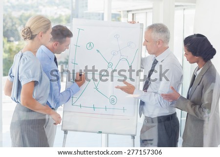 Business team talking about the graph on the whiteboard in the office