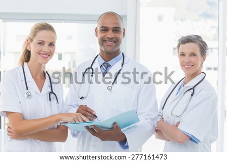 Team of doctors working together on patients file in medical office