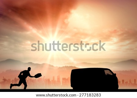 Delivery man with cardboard boxes running against sun shining over road and city