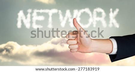 Hand showing thumbs up against clouds spelling out network