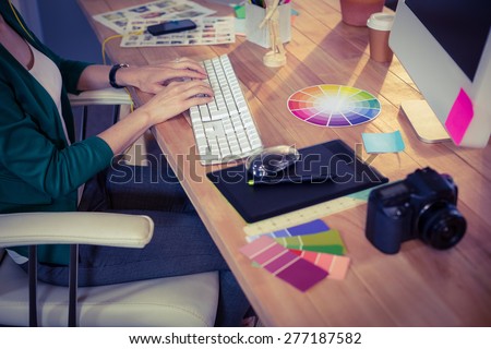 Designer working at her desk in creative office