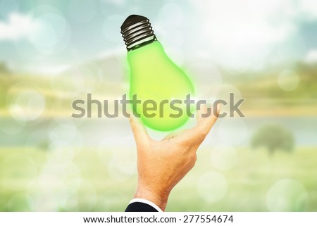 Businessman pointing with his finger against grey abstract light spot design