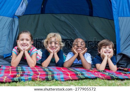 Happy siblings on a camping trip on a sunny day