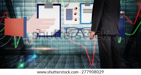 Businessman standing against stocks and shares on black background