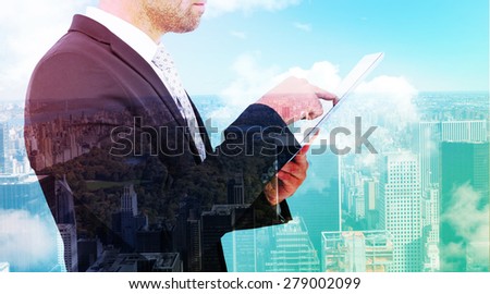 Businessman using his tablet pc against new york