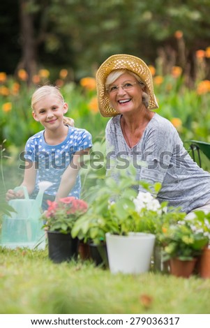 Happy grandmother and grandfather gardening on a sunny day
