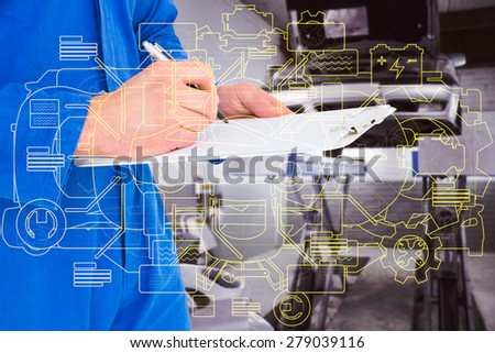 Male mechanic writing on clipboard against auto repair shop