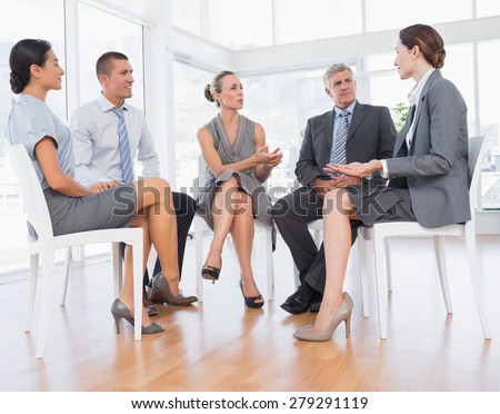 Business team sitting in circle and discussing in the office