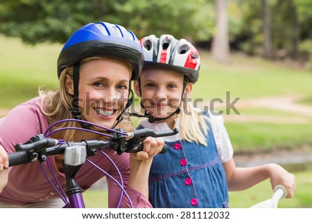 Mother and her daughter on their bike on a sunny day