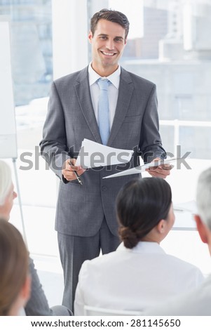 Happy businessman looking at camera during meeting in meeting room