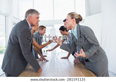 Irritated business team arguing in the office