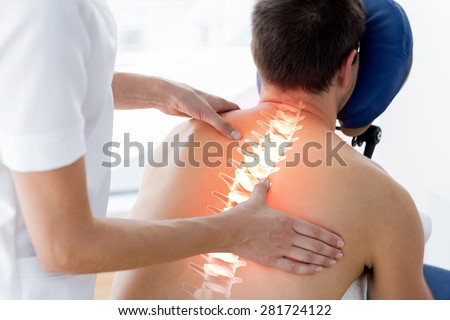 Digital composite of Highlighted spine of man at physiotherapy