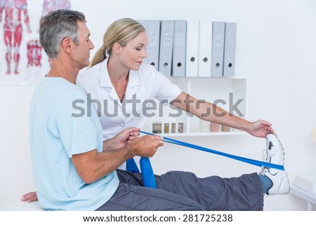 Doctor examining her patient back legs in medical office
