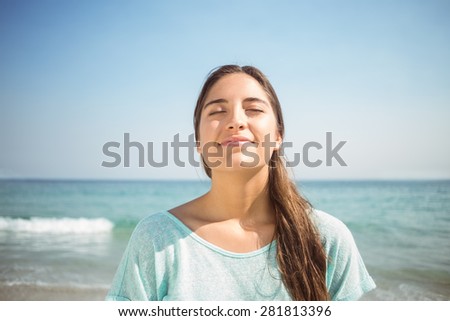 happy woman smiling at the camera at the beach